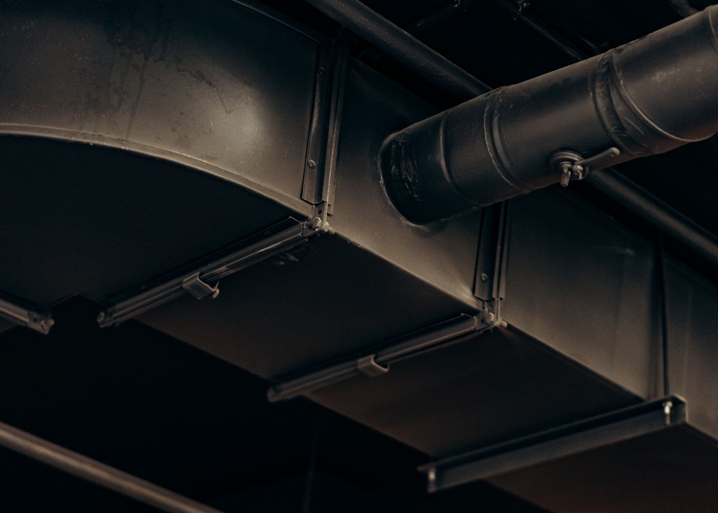 Metal ventilation ductwork installed along a ceiling